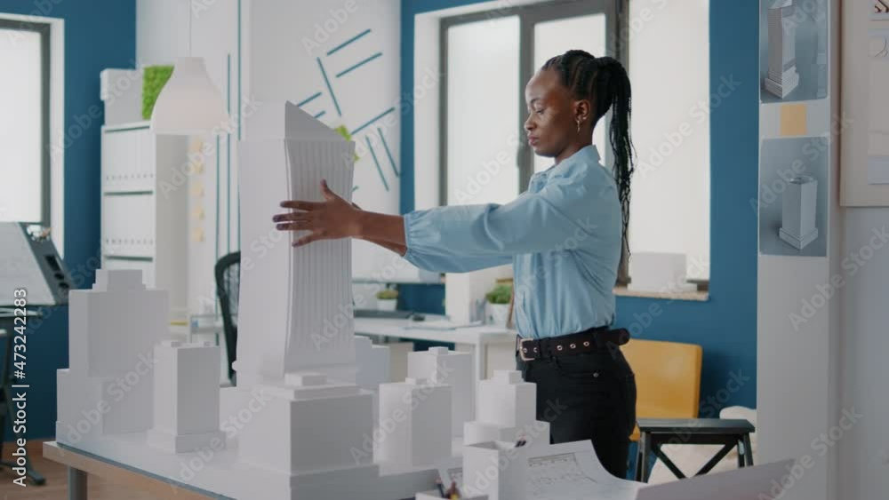 Poster woman placing blueprints plan on table to design building model and construction layout. architect u