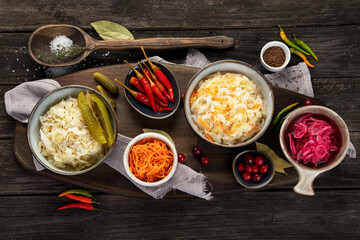 Pickled vegetables on wooden background. Salting vegetables.