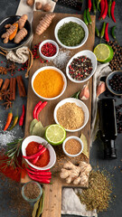 Assortment of spices on gray background.