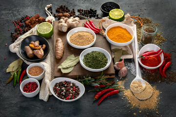 Assortment of spices on gray background.