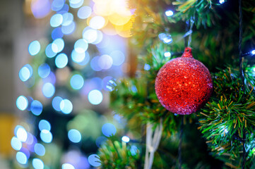 Closeup Christmas Tree decorations  with bright red balls on blurred sparkling fairy background