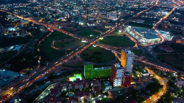 Aerial time-lapse view of traffic at night in Accra, Ghana during sunset
