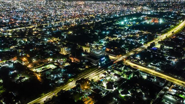 Aerial time-lapse view of traffic at night in Accra, Ghana with drone push in