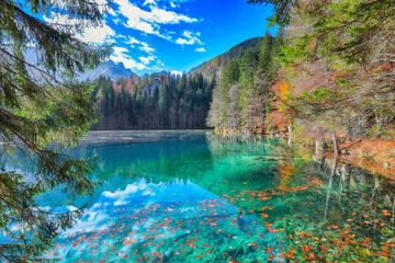 Fairytale  view of Fusine lake with Mangart peak on background