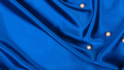pearls on blue luxury satin fabric. Background. elegant wallpaper