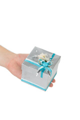 Gift box with blue bow in hand.