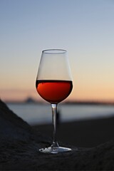glass of red wine at sunset