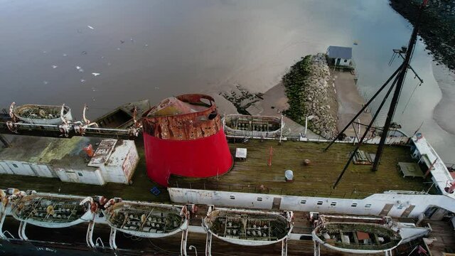Abandoned railway steamer ship TSS Duke of Lancaster beached near Mostyn Docks, on the River Dee - aerial pullback