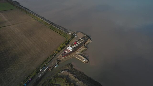Rural Landscape And Tss Duke Of Lancaster Vessel On Sandy Coast - aerial drone shot