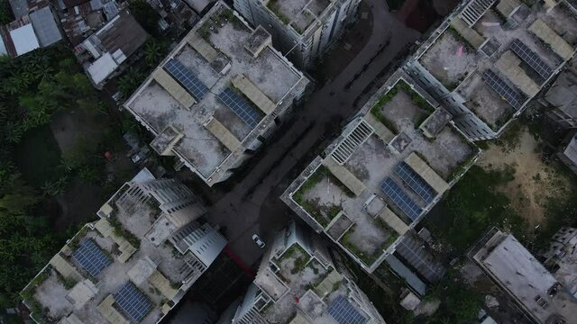 Solar panels on old Bangladesh residential apartment blocks, aerial top down