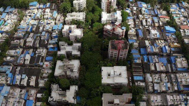 Aerial View Of Houses And Buildings In Mumbai Suburban District In Maharashtra, India.- tilt down