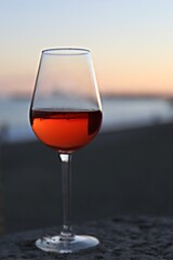 glass of red wine on the beach