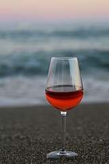 glass of red wine on the beach