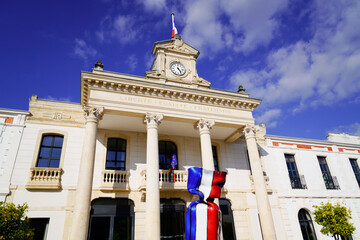 city hall in town center of arcachon with french flag on candy text liberte egalite fraternite...