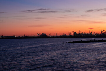Naklejka premium landscape with the silhouettes of cranes from the port of Constanta in the evening