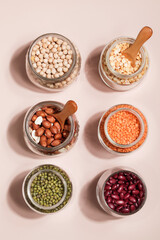Vegan protein source. Beans, peas, chickpeas, lentils, mung bean, peanut in bowl on beige background. Healthy vegetarian food. copy space
