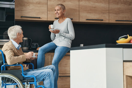 Happy senior woman laughing at funny story