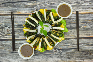 Grilled beef with guise leaves ( Bo Lui). Ingredients include vermicelli, grilled beef with pandan leaves, raw bananas, raw vegetables and seasoned fish sauce