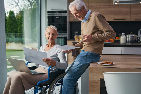 Two happy people drinking tea in the kitchen