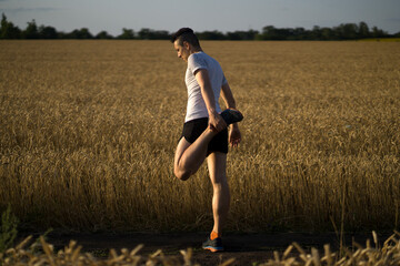 Obraz na płótnie Canvas Man jogging along the trail at sunset.