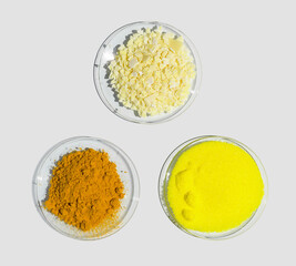 Sodium sulfide flake, Potassium Chromate and Organic Curcuma Powder in Chemical Watch Glass. Closeup chemical ingredient on white laboratory table. Top View