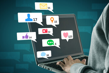Close up of hacker hand using laptop computer with creative social media icons on abstract background. Like, network, technology and communication concept.
