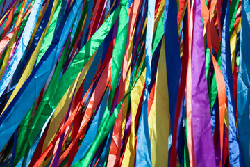 Large numbers of satin ribbons of different colors flutter in the wind