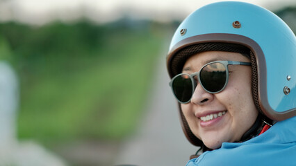 woman wearing a helmet before riding a motorcycle