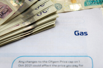 A gas bill with bank notes. Raising energy cost.