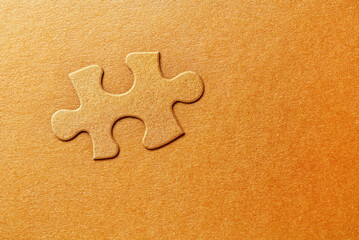 Golden embossed puzzle piece