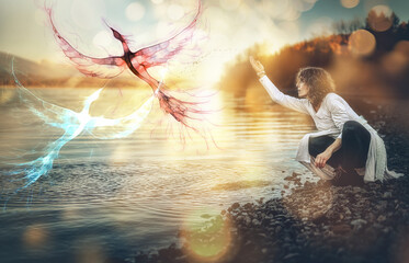 beautiful shamanic girl and phoenix in the nature.