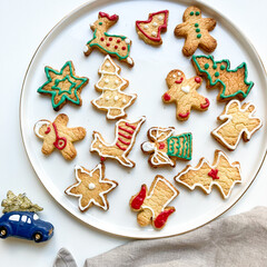 Homemade colorful Christmas cookies on a white plate. Holiday season and decoration. 
