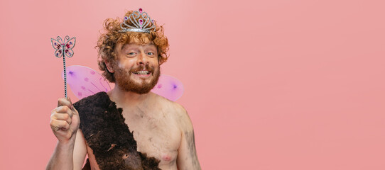 Cropped portrait of cheerful happy man in character of neanderthal wearing little fairy crown...