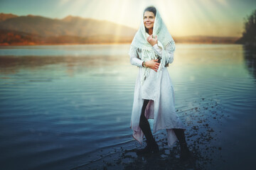 misty woman covered with a scarf in the nature.