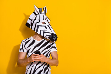 Profile side photo of weird guy in zebra mask blog use smart phone chatting empty space isolated...