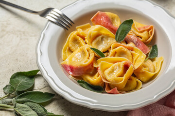 Close-up of trendy two-tonned stuffed italian pasta - tortelloni with ricotta and red radicchio,...
