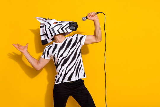 Profile side photo of freak guy in zebra mask sing mic popular song isolated over bright yellow color background