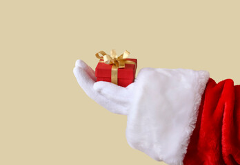 Santa Claus's hand holds a gift