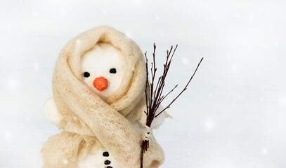 Snowman on a light background with a broom