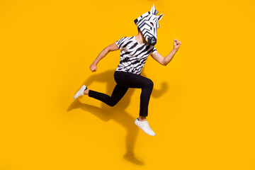 Photo of funky hurrying guy dressed wild animal costume running fast jumping high isolated yellow color background