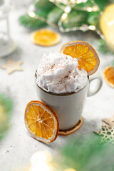 A cup of cocoa or hot chocolate with whipped cream on a Christmas or New Year light background	