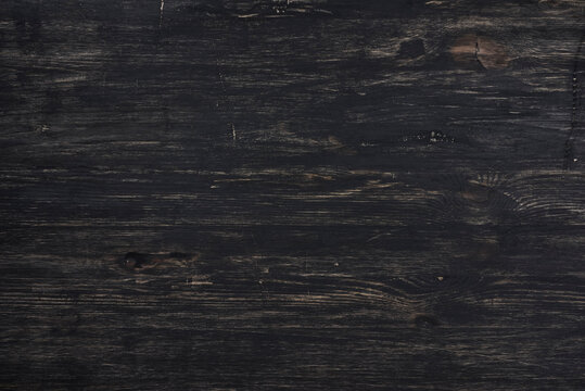 Dark stained rough wood texture full frame abstract background