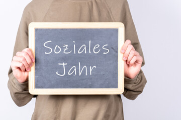 Jugendlicher oder Schüler mit einer Tafel auf der Soziales Jahr steht