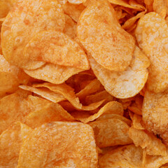 Potato chips or crisps . Close-up of potato chips or crisps. Food background.