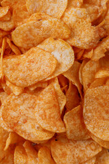 Potato chips or crisps . Close-up of potato chips or crisps. Food background.