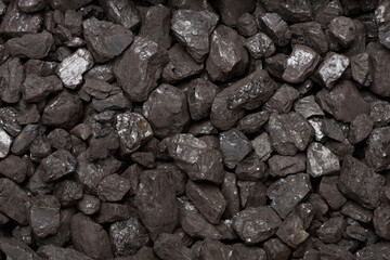 Natural black stone coal background top view. Fossil fuel coal lumps texture.