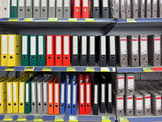 Multicolored Files and folders with blank labels displayed on store shelf.