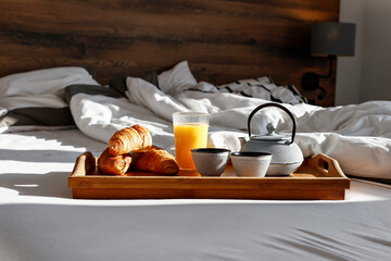 Fototapeta na wymiar Breakfast in bed on a beautiful morning and an empty seat, hot coffee on a wooden platform 