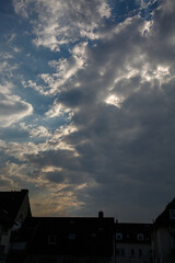 Dramatic clouds and blue sky over the roofs