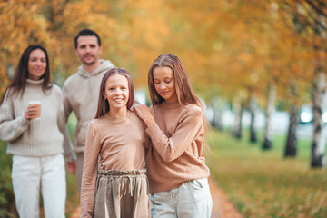 Portrait of happy family of four in autumn